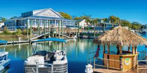 a marina with two boats and a building at 2Br 2Ba Condo on Golf Course in Pawleys Island