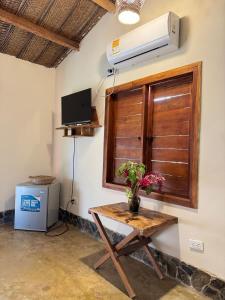 a room with a table and a air conditioner on the wall at Tayrona Cachaco River Ecohostal in El Zaino