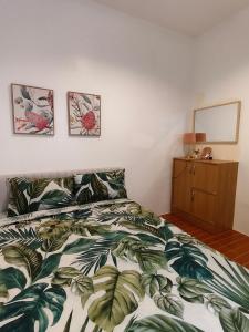 a bedroom with a bed with a green and white comforter at Graceland in Lapu Lapu City