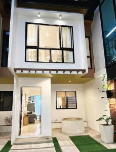 a house with a large window and a living room at Graceland in Lapu Lapu City