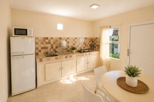 a kitchen with a table and a white refrigerator at Altos de Alem in Federación