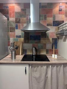 a kitchen with a sink and a stove at Casa Carmen I in Montoro