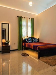 a bedroom with a bed and a window with green curtains at Papa's Resort Dunhinda in Hinnarangahakumbura