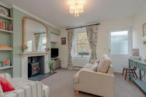 a living room with two couches and a fireplace at Three Peaks Central Cottage, Settle, 3Bed 2Bath in Settle