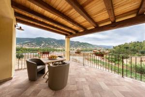 a balcony with a table and chairs and a view at Agriturismo Cirra in Tertenìa