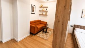a living room with a couch and a bed at Evo Residence Taietura Turcului in Cluj-Napoca +243 photos