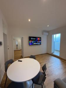 a meeting room with a white table and chairs at Civico 8 Apartment in Sassari