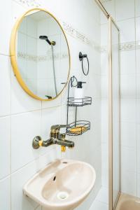 a bathroom with a sink and a mirror at Nature Apartment Karlovy Vary Kolová in Karlovy Vary +20 photos