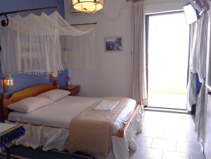 a bedroom with a bed and a large window at Chios Panorama in Karfas +44 photos