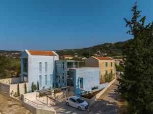 a white car parked in front of a building at Anassa House with Rooftop Jacuzzi in Vamos