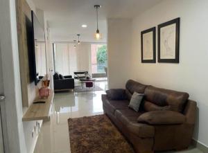 a living room with a brown couch and a table at Imperial house in Envigado