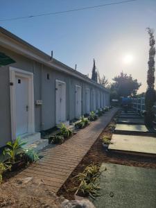 a row of buildings with white doors and plants at AG Hotel in Dhërmi