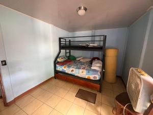 a small bedroom with a bunk bed in a room at Elsie Place in San Mateo +1 photo