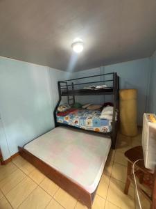 a small bedroom with a bunk bed in a room at Elsie Place in San Mateo