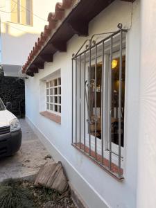 a white building with a window with bars on it at Marea in San Lorenzo +13 photos