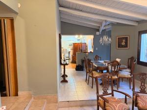 a dining room and living room with a table and chairs at Marea in San Lorenzo