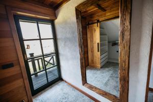 a mirror in a room with a window at Zidanica Pobežin in Rogaška Slatina