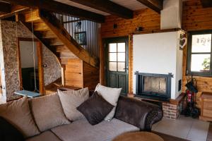 a living room with a couch and a fireplace at Zidanica Pobežin in Rogaška Slatina