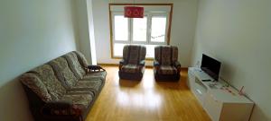 a living room with a couch and two chairs at EnSAN CIPRIAN Playas y Relax in San Ciprián +15 photos