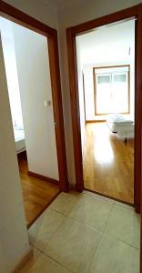 a room with two doors and a room with a bed at EnSAN CIPRIAN Playas y Relax in San Ciprián