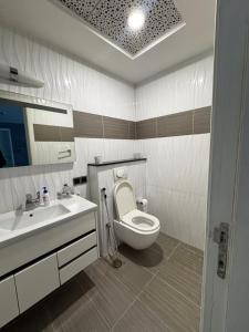 a bathroom with a toilet and a sink at Penta Prestige Hotel Apartments DHA Lahore - LMY Hospitality in Lahore