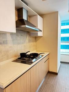 a kitchen with a stove and a counter top at Penta Prestige Hotel Apartments DHA Lahore - LMY Hospitality in Lahore