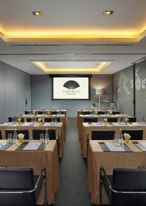 a conference room with tables and a projection screen at Mandarin Oriental, Barcelona in Barcelona +163 photos