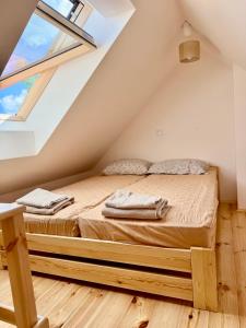 a bedroom with a bed in a attic at Agroturystyka Evita in Jabłeczna