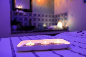 two candles are sitting on top of a bed at EVASION by LIBERTE in Oran