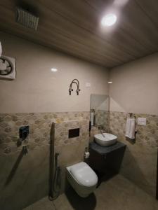 a bathroom with a toilet and a sink at Summer Hill Resort in Chail