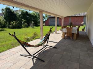 a hammock on the patio of a house at Agroturystyka Evita in Jabłeczna