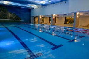 a swimming pool at night with blue lighting at EVASION by LIBERTE in Oran