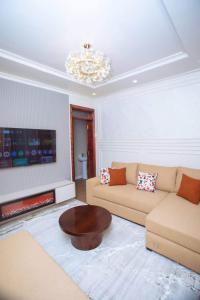 a living room with a couch and a coffee table at Elazoh Apartments in Kisumu +1 photo