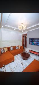 a living room with a couch and a table at Elazoh Apartments in Kisumu