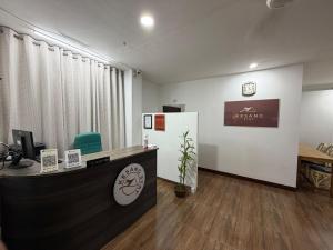 an office with a reception desk and a refrigerator at Kesang Stay in Diphu