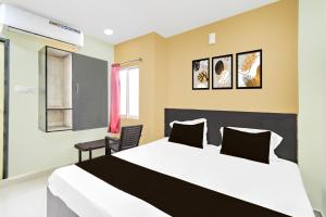 a bedroom with a large bed and a chair at Hotel O HOLIDAY STAR IN in Hyderabad