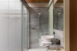 a bathroom with a sink and a glass shower at Anassa House with Rooftop Jacuzzi in Vamos +42 photos