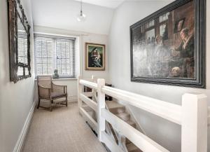 a staircase in a home with a large painting on the wall at Raphael Rooms in Peterborough