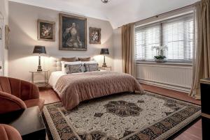 a bedroom with a large bed and a window at Raphael Rooms in Peterborough