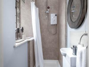 a bathroom with a shower and a sink at Raphael Rooms in Peterborough +11 photos