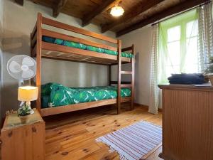 a bedroom with two bunk beds and a window at Villa Felinas in Ahun