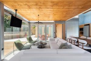 a living room with a white couch and chairs at Anassa House with Rooftop Jacuzzi in Vamos