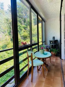 a room with large windows and a table and chairs at MULINO DELLA VALLE in Cittiglio +17 photos