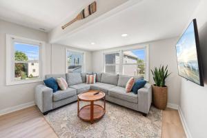 a living room with a couch and a table at Bradley Beach Compound in Bradley Beach