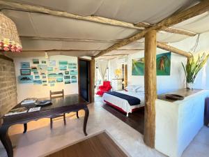 a bedroom with a bed and a desk at Oca House in Búzios +35 photos