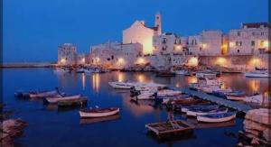a group of boats docked in a harbor at night at Sogno nella Corte in Bitonto
