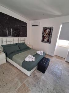 a bedroom with a bed with two towels on it at Sogno nella Corte in Bitonto