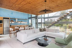 a living room with a white couch and a table at Anassa House with Rooftop Jacuzzi in Vamos