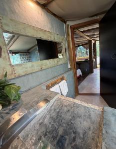 a bathroom with a sink and a mirror at Oca House in Búzios