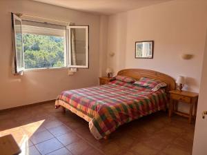 a bedroom with a bed and a window at EL MIRADOR in Alaior +10 photos